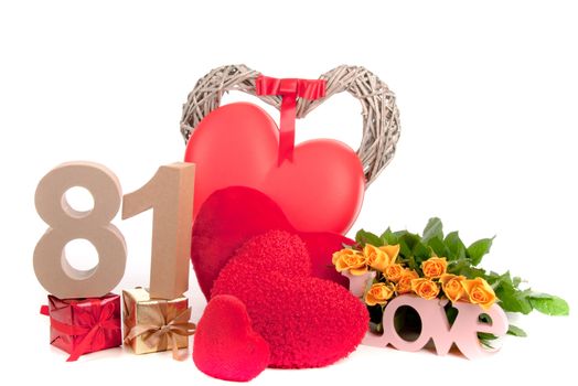 Number of age in a colorful studio setting with heart and gifts and yellow roses