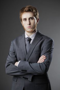 Portrait of young business man with arms crossed