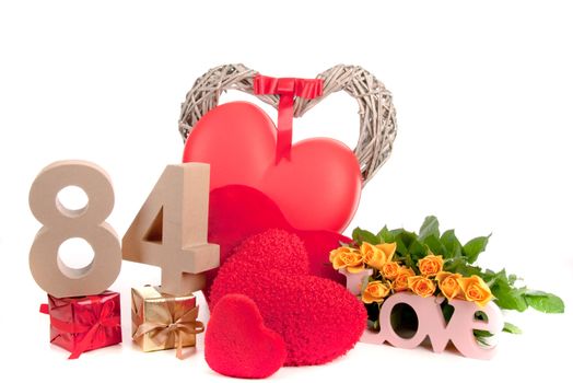 Number of age in a colorful studio setting with heart and gifts and yellow roses