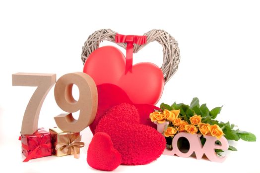 Number of age in a colorful studio setting with heart and gifts and yellow roses