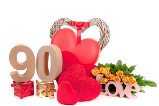 Number of age in a colorful studio setting with heart and gifts and yellow roses