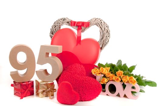 Number of age in a colorful studio setting with heart and gifts and yellow roses
