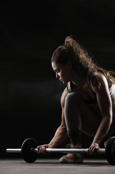 Young woman lifting weights