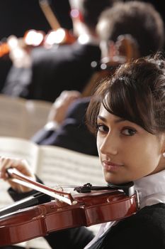 Violinist woman playing a concert of classical music