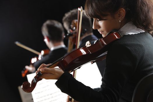 Violinist woman playing a concert of classical music