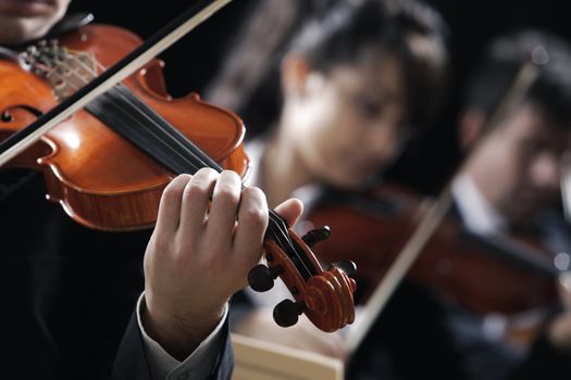 Symphony music, violinist at concert, hand close up