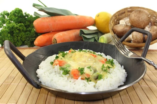 a pan with rice and colorful chicken fricassee