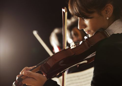 Violinist woman playing a concert of classical music