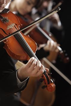 Symphony music, violinist at concert, hand close up