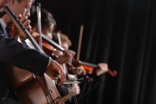 Symphony concert, a man playing the cello, hand close up