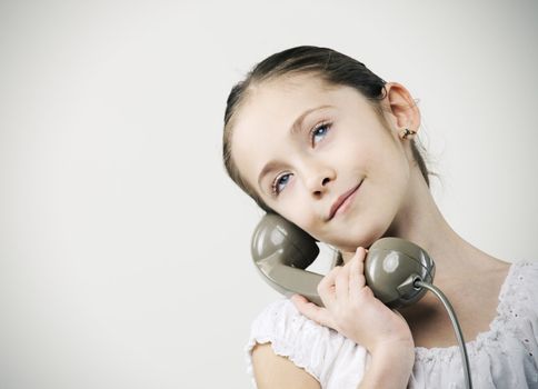 Cute young girls talking on phone