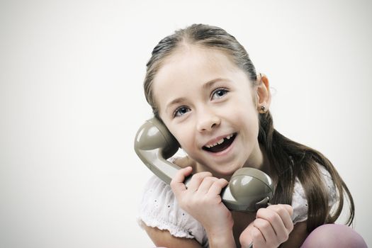 Cute young girls talking on phone