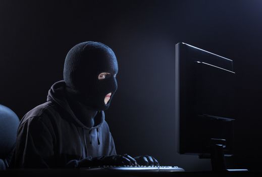 Computer hacker - Male thief stealing data from computer