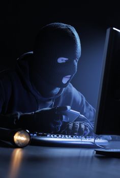 Computer hacker - Male thief stealing data from computer