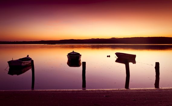 Beautiful landscape of a river and boats at sunset