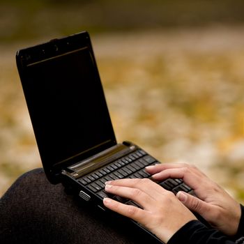 Close-up of female hands working on a laptop