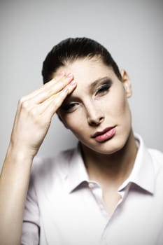 Beautiful woman having headache with hands on temple