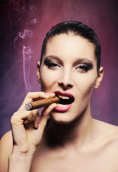 Attractive young woman smoking a cigar, portrait of fashion model