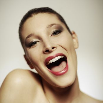 Portrait of beautiful laughing woman happy and cheerful, focus on mouth