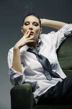 Sensual woman smoking a cigarette, fashion model