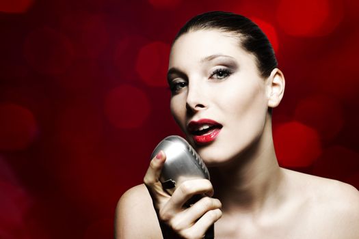 Beautiful female singer with vintage microphone