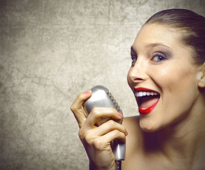 Beautiful female singer with vintage microphone