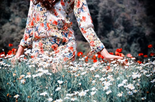 women in walk and pat flower in the garden