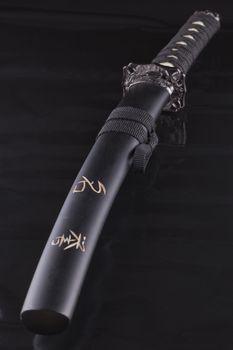 Close up of a katana over a black background