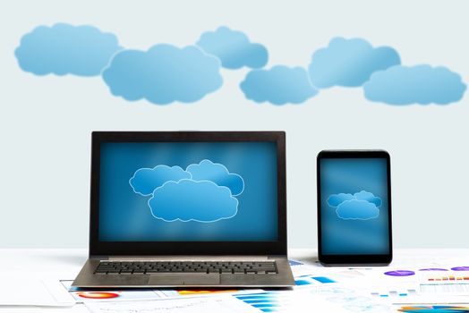 notebook, tablet and business documents with charts, concept of cloud technologies