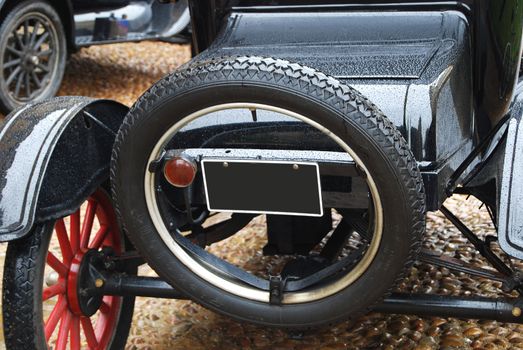 Black retro car back side, spare wheel closeup