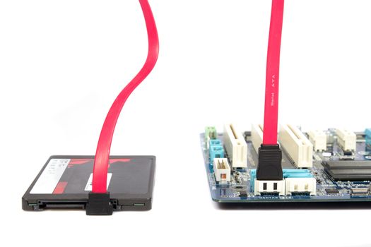 SSD disk and sata connection on the computer motherboard on a white background