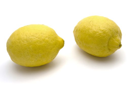 Two Fresh lemons closeup on white background