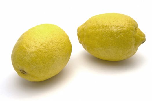 Two fresh lemons closeup on white background