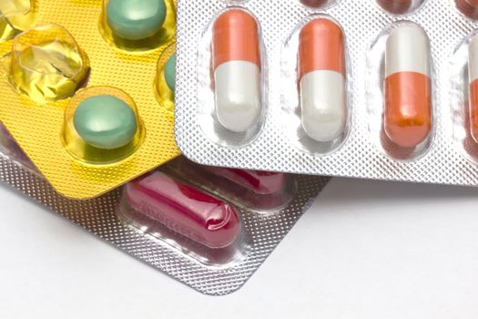 Colorful pills closeup on white background 

