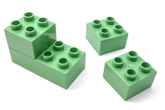 Green building blocks closeup on white background 
