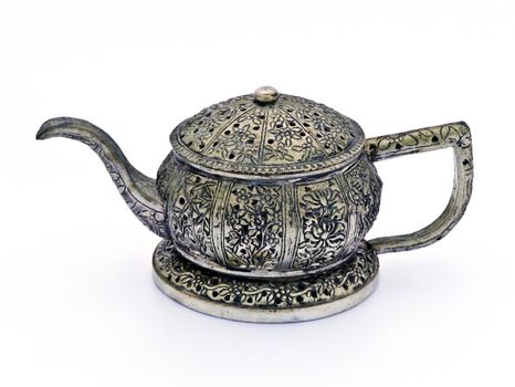 Antique tea pot and cups made ​​of metal, isolated on a white background.