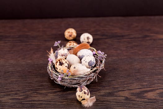 easter decoration with quail eggs on wooden background