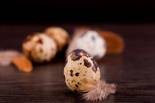 easter decoration with quail eggs on wooden background