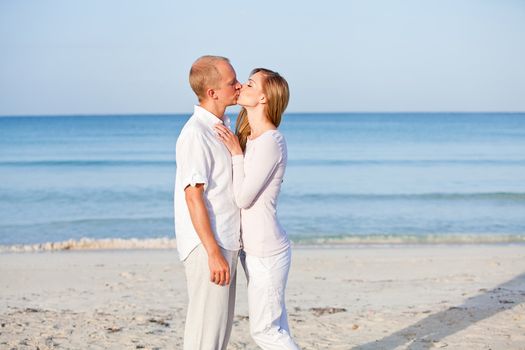 happy young couple in love having fun on the beach blue sky and sunshine 