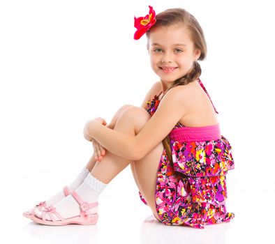 Pretty girl sitting on white background in studio. Vertical view