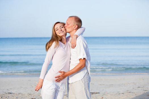 happy young couple in love having fun on the beach blue sky and sunshine 