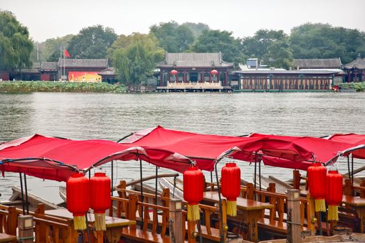 Red Boats Houhai Lake Beijing, China.  Houhai Lake is the old swimming hole in Beijing and is now surrounded by bars and restaurants.