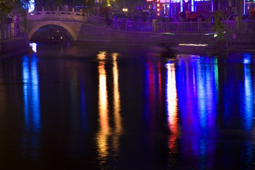 Houhai Lake Bar District Silver Ingot Bridge Blue Lights at Night with Reflections Beijing China