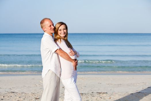 happy young couple in love having fun on the beach blue sky and sunshine 