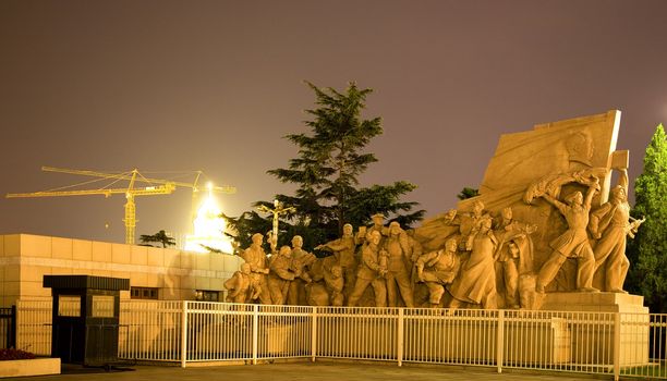 Mao Statue in front Mao Zedong Tse Tung Tomb Tiananmen Square Beijing, China Night Shot  Yellow Building Crane in Background