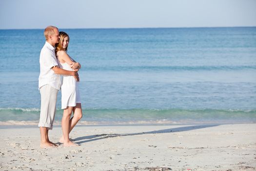 happy young couple in love having fun on the beach blue sky and sunshine 