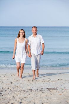 happy young couple in love having fun on the beach blue sky and sunshine 