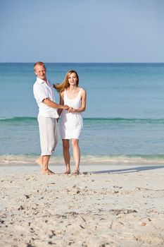 happy young couple in love having fun on the beach blue sky and sunshine 