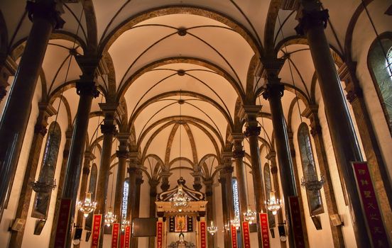 St. Joseph Wangfujing Cathedral, Basilica, Interior Church Beijing China.  Very famous Catholic Church built in 1655 and in Boxer Rebellion 
Chinese Character signs are Christian sayings in Chinese