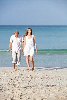 happy young couple in love having fun on the beach blue sky and sunshine 